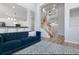 Spacious living room with soaring ceilings, wood floors, and view of staircase and kitchen with breakfast bar at 1236 Aquila Loop, Celebration, FL 34747
