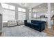 Bright living room features vaulted ceilings, large windows, plush seating, and stylish decor, creating an inviting atmosphere at 1236 Aquila Loop, Celebration, FL 34747