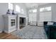 Comfortable living room featuring a fireplace, ample natural light, and stylish furnishings at 1236 Aquila Loop, Celebration, FL 34747
