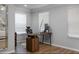 Bright home office with a modern desk, ergonomic chair, two windows and luxury vinyl plank flooring at 1236 Aquila Loop, Celebration, FL 34747