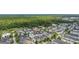 Aerial view showcases the neighborhood's layout with its proximity to a tranquil pond and mature trees at 1592 Castile St, Celebration, FL 34747