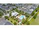 Aerial view highlighting a luxurious community pool, clubhouse, and lush, mature landscaping at 1592 Castile St, Celebration, FL 34747