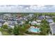 Aerial view featuring a community pool with lush landscaping and proximity to the community clubhouse at 1592 Castile St, Celebration, FL 34747