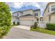 Two-story home featuring a two-car garage and a well-maintained front yard at 1592 Castile St, Celebration, FL 34747