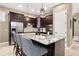 Modern kitchen with dark cabinets, stainless steel appliances, and a granite island with bar seating at 1592 Castile St, Celebration, FL 34747