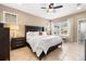 Bright main bedroom with a large bed, dark wood furniture, and ample natural light through large windows at 1592 Castile St, Celebration, FL 34747