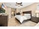 Bright main bedroom showcasing a ceiling fan, flat-screen TV, and ample space with tasteful decor at 1592 Castile St, Celebration, FL 34747