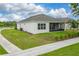 Well-manicured lawn in the backyard featuring a screened in patio at 1598 Whitewood Ct, Kissimmee, FL 34747