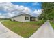 View of backyard showing screened lanai and lush landscaping at 1598 Whitewood Ct, Kissimmee, FL 34747