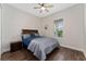 Cozy bedroom featuring hardwood floors, a ceiling fan, a window, and comfortable furnishings at 1598 Whitewood Ct, Kissimmee, FL 34747