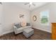 Relaxing bedroom with neutral tones, a comfortable sofa, and a window providing natural light at 1598 Whitewood Ct, Kissimmee, FL 34747
