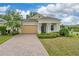 Charming one-story home with a brick-paved driveway and beautifully maintained front yard landscaping at 1598 Whitewood Ct, Kissimmee, FL 34747