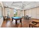 Spacious game room with a pool table, ping pong, chandelier, and plenty of space to relax and play at 1598 Whitewood Ct, Kissimmee, FL 34747