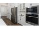 Gourmet kitchen featuring stainless steel appliances, white cabinetry, built-in microwave and oven, and sleek design at 1598 Whitewood Ct, Kissimmee, FL 34747