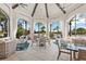 Cozy lounge area with comfortable seating and large arched windows overlooking the pool and grounds at 1598 Whitewood Ct, Kissimmee, FL 34747