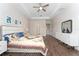 Bright, spacious main bedroom showcasing a tray ceiling, hardwood floors, and a serene, neutral color scheme at 1598 Whitewood Ct, Kissimmee, FL 34747