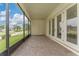 Covered screened patio with brick pavers, providing an ideal space for outdoor entertaining at 1598 Whitewood Ct, Kissimmee, FL 34747