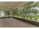 Relaxing screened patio with brick pavers, providing a serene outdoor space surrounded by lush greenery at 1598 Whitewood Ct, Kissimmee, FL 34747