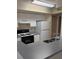 Functional kitchen featuring white cabinets, laminate countertops, and essential appliances at 1608 Columbia Arms Cir # 126, Kissimmee, FL 34741