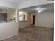 Open living room featuring neutral paint, carpeted floors, and an opening to the kitchen area at 1608 Columbia Arms Cir # 126, Kissimmee, FL 34741