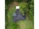 Birds eye view of a black roof house, yard, and surrounding foliage at 1615 Ne 9Th St, Ocala, FL 34470