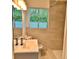 Bathroom featuring a stylish vanity, shower, and window at 1615 Ne 9Th St, Ocala, FL 34470