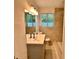 Bathroom showcasing modern sink, mirror, and tiled shower at 1615 Ne 9Th St, Ocala, FL 34470