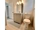 Neutral bathroom with a modern vanity, toilet, mirror, and shower at 1615 Ne 9Th St, Ocala, FL 34470