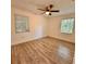 Bedroom with natural light, ceiling fan, and wood-look floors at 1615 Ne 9Th St, Ocala, FL 34470