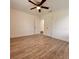 Bedroom with wood floors, ceiling fan, and neutral walls at 1615 Ne 9Th St, Ocala, FL 34470