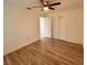 Bright bedroom with wood-look floors, ceiling fan, and closet at 1615 Ne 9Th St, Ocala, FL 34470