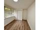 Bright bedroom with wood-look flooring, a large window and closet at 1615 Ne 9Th St, Ocala, FL 34470