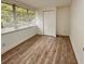 Bright bedroom with wood-look flooring, a large window and closet at 1615 Ne 9Th St, Ocala, FL 34470