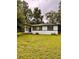 Charming single-story home with a well-maintained lawn and mature trees at 1615 Ne 9Th St, Ocala, FL 34470