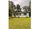 Charming single-story home with a well-maintained lawn and mature trees at 1615 Ne 9Th St, Ocala, FL 34470