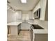 Bright kitchen with stainless steel appliances, white cabinets and stone countertops at 1615 Ne 9Th St, Ocala, FL 34470