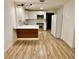 Bright kitchen featuring white cabinetry, stainless steel appliances, and wood-look flooring at 1615 Ne 9Th St, Ocala, FL 34470
