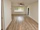 Bright living room with a large window, wood-look flooring, and neutral paint at 1615 Ne 9Th St, Ocala, FL 34470