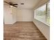 Bright living room featuring modern flooring, ample natural light and a ceiling fan at 1615 Ne 9Th St, Ocala, FL 34470