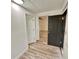 Bright room with laminate flooring and multiple doorways at 1615 Ne 9Th St, Ocala, FL 34470