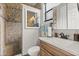 Bathroom featuring tiled walk-in shower, wood vanity with white countertop, mirror, and neutral color scheme at 1704 Pine Ridge Dr, Davenport, FL 33896