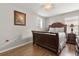 Bedroom featuring wood floors, a large bed with a decorative headboard, and natural lighting at 1704 Pine Ridge Dr, Davenport, FL 33896