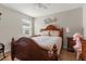 Comfortable bedroom featuring hardwood floors, a large bed, bedside tables and decor at 1704 Pine Ridge Dr, Davenport, FL 33896