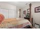 Cozy bedroom featuring a four-poster bed, wood floors, closet, and view into another room at 1704 Pine Ridge Dr, Davenport, FL 33896