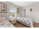 Comfortable bedroom with twin bed and bedside table, featuring light-filled windows and cozy decor at 1704 Pine Ridge Dr, Davenport, FL 33896