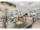 Open dining space showcasing seamless transition to the kitchen and living area with chandelier at 1704 Pine Ridge Dr, Davenport, FL 33896