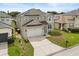 An exterior shot displaying the home's architecture, attached garage, and surrounding yard at 1704 Pine Ridge Dr, Davenport, FL 33896