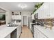 Modern kitchen featuring white cabinets, stainless steel appliances, a mosaic tile backsplash, and ample counter space at 1704 Pine Ridge Dr, Davenport, FL 33896