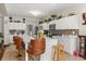 Bright kitchen featuring white cabinets, decorative backsplash, chandelier, and a spacious island with bar seating at 1704 Pine Ridge Dr, Davenport, FL 33896