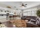 Open-concept living space connecting to a modern kitchen, with tile and hardwood flooring at 1704 Pine Ridge Dr, Davenport, FL 33896